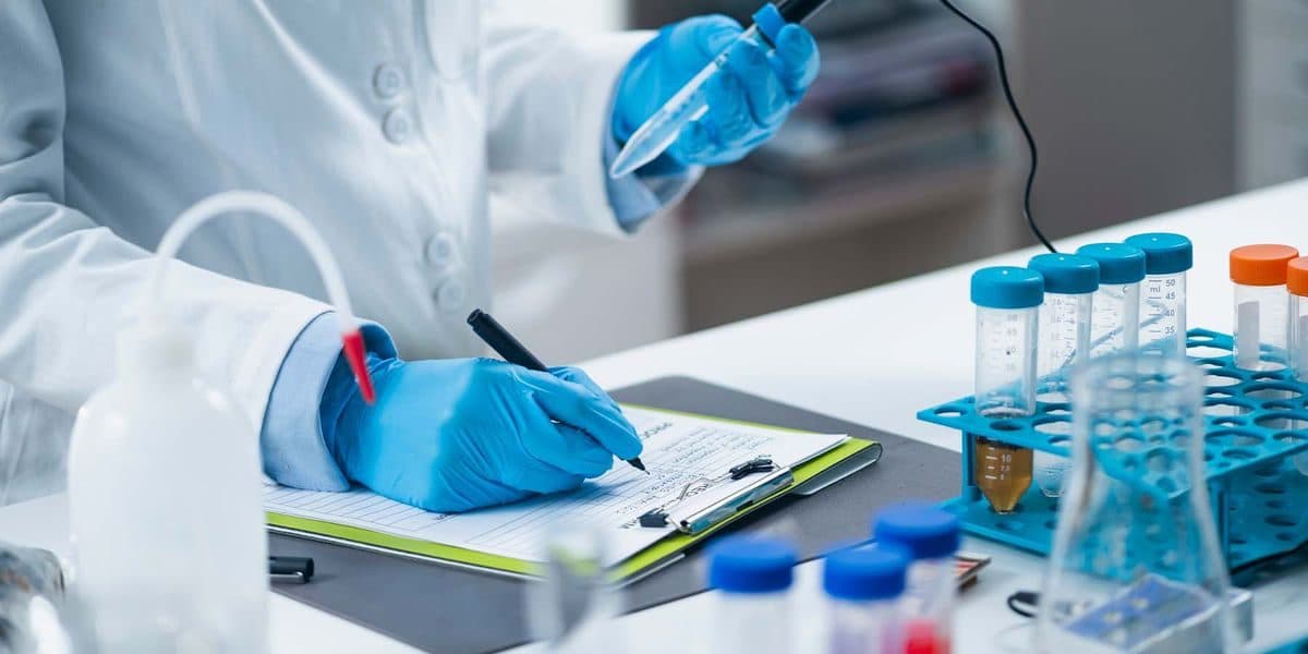 Laboratory technician documenting a sample test