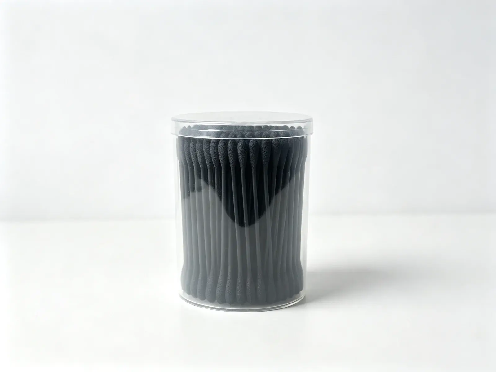 Jar of black spiral-wound cotton swabs